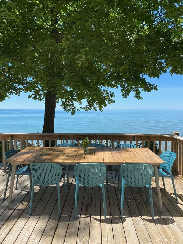 Large lakeside deck ready for outdoor meals. 
