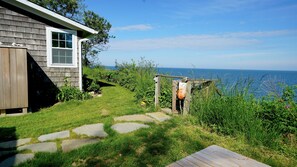 Outdoor shower and stone path leading to the stairs to the private beach 