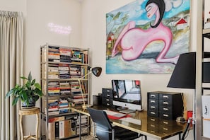 Stay productive in the dedicated workspace, equipped with a desk and an Apple monitor, providing an inspiring environment for remote work.
