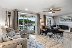 Downstairs Living Room. Access to Lower Deck and Lakefront. Tan Sleeper Sofa (Q)