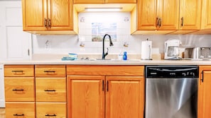 Our kitchen holds all the essential cookware, full-sized stove/oven, microwave, and dishwasher.