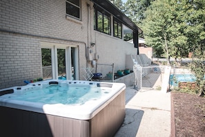 Exclusive Hot Tub Nestled at the Rear of the House, Adjacent to a Private Fenced Pool for Your Convenience.