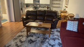 The Apartment is open concept. The leather couch has two recliners. 