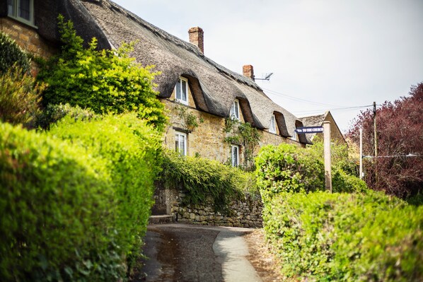The cottage is accessed via a raised pavement.