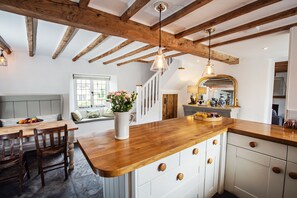 The kitchen has a breakfast bar and table to seat 5. 