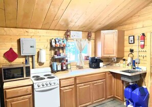 This dry cabin has a foot-pump sink, a  crockpot, coffee bar and more.