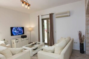 Relax in the cozy living room space, blending comfort and style seamlessly