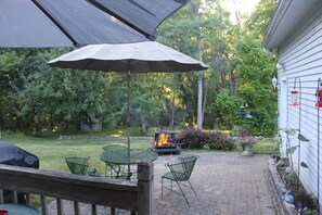 Backyard: 2 tables & umbrellas, grill & fire-pit. Birds, deer & other wildlife.