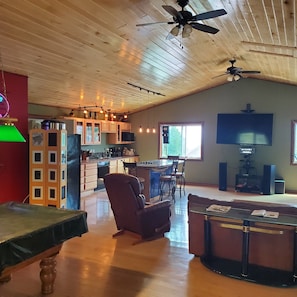 Greatroom view from entryside. Entertainment system, with Alexa in background.