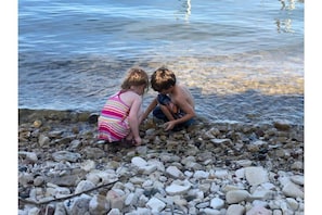 Children searching for treasure stones near guest dock.