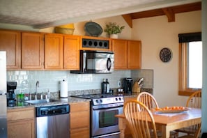Dining and full kitchen, equipped with Keurig and drip coffee maker. Oil/vinegar/spices/salt & pepper provided, along with cookware, dishware, & cutlery.