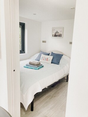 Bedroom with standard double bed, wardrobe with 4 drawers. Hooks for coats.