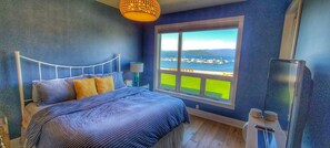 Master bedroom with lake and mountain views as well as access to the balcony.