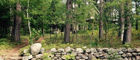 The Bishops Camp from the access road. House at top, boat house and lake behind