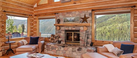 Open living area w/ vaulted ceilings and large wood burning fireplace