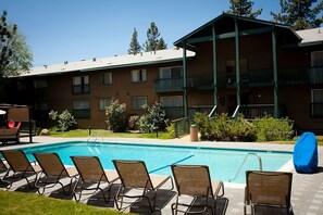 Large heated swimming pool and poolside loungers