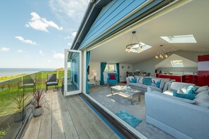 Sunset, Overstrand: Bi-fold doors open to the glazed terrace