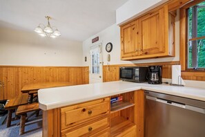 Functional kitchen with wooden cabinets.