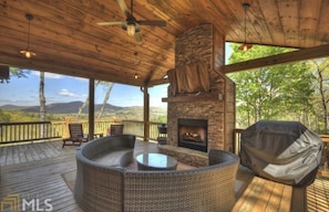 Outdoor seating, gas grill and wood burning fireplace on the main level deck