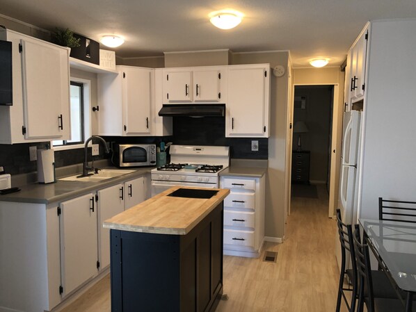 Fully stocked with pots pans dishes utensils etc. has microwave and fridge.