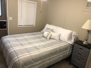 Comfy queen bed the room has a TV a fire stick & a dresser for your belongings.