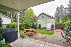 Peaceful backyard retreat with grill and dining.