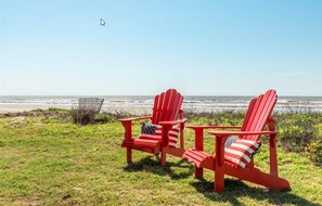 Steps from the beach. Beach access on left side of chairs. 