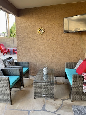 Covered patio seating and smart tv for outdoor entertainment