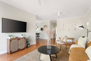 Open living room with a Smart TV, Sling & Netflix