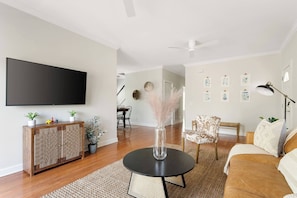 Open living room with a Smart TV, Sling & Netflix