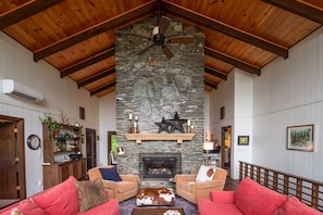 Soaring vaulted wood beam ceilings & 2-sided gas bluestone fireplace.