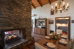 Dining Area with fireplace & view out back of house.