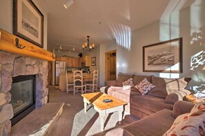 Cozy Living Room space with gas fireplace, pullout bed, and sliding glass door to a furnished patio overlooking the mountain!