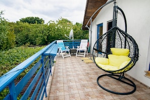 Second floor deck with a hanging chair