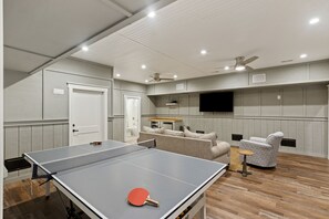 Basement Living Room with TV and Ping Pong