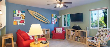 Living room with couches, TV, ceiling fan