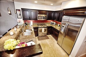 Kitchen with stainless steel appliances, kitchen, gas stove, refrigerator, dishwasher, sink, microwave, standard coffee maker and toaster