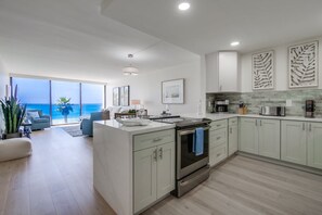 Brand new kitchen with stunning marble countertops, stainless steel appliances and open design. Everything you need for meals at home!