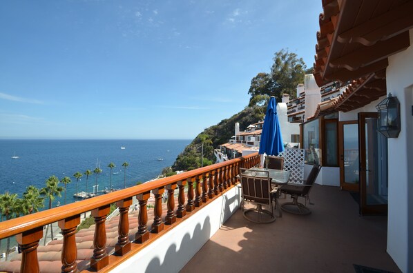 Private balcony with table, umbrellas and seating for 3