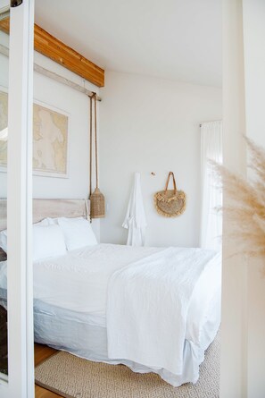 Downstairs bedroom with luxury queen mattress and water views