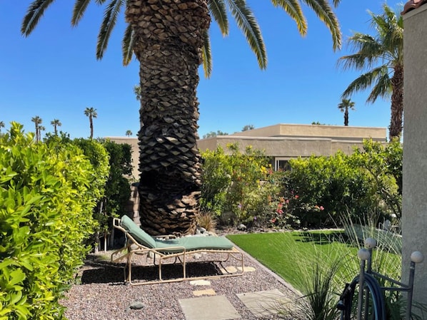 The patio leads to this landscaped fenced-in yard