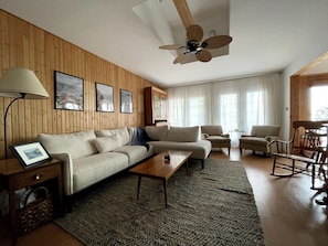 Living room with fireplace, and 46" smart TV. 