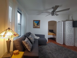 The living room has newly restored original wood floors.