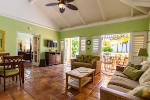 Living room and dining area. Whole home has terra cotta floor tiles. 