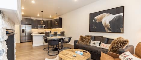 Living area featuring flat screen TV, sleeper sofa, gas fireplace, and balcony attached.