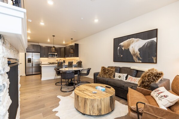 Living area featuring flat screen TV, sleeper sofa, gas fireplace, and balcony attached.