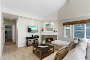 Living room with gas fireplace, cable TV, and balcony access