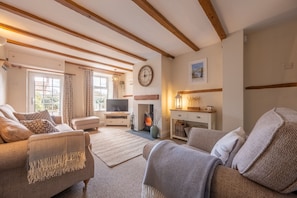 3 Chapel Cottages, Docking: Sitting room with a wood-burning stove