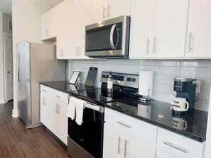 Luxury Apartment; Kitchen with island, granite counter tops, stainless steel appliances