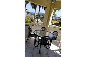 Veranda with nice ocean views . Outdoor ceiling fan for an extra breeze.